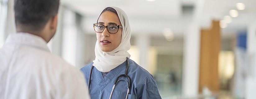 Female doctor discussing with male doctor