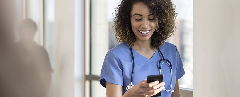 Nurse uses EHR applications on mobile phone