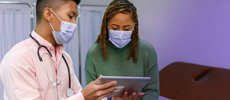Image of physician and patient reviewing electronic health record