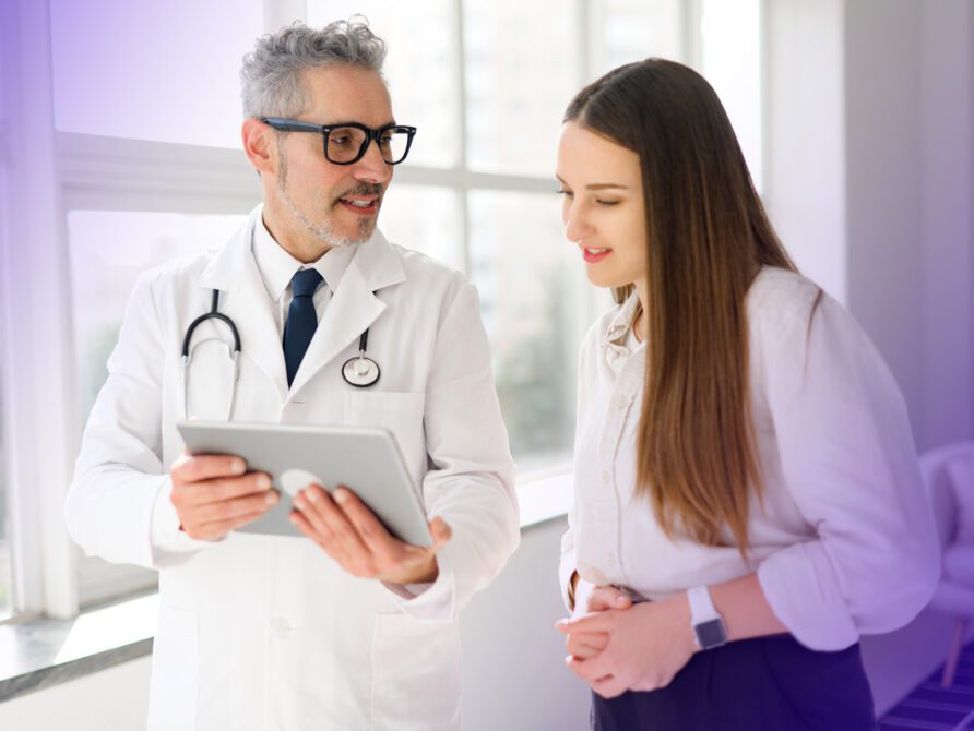 Doctor and patient looking at EHR on tablet