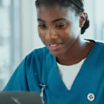 nurse at computer using EHR software