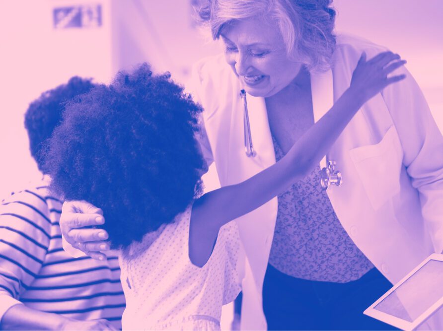 doctor hugging child who is a patient